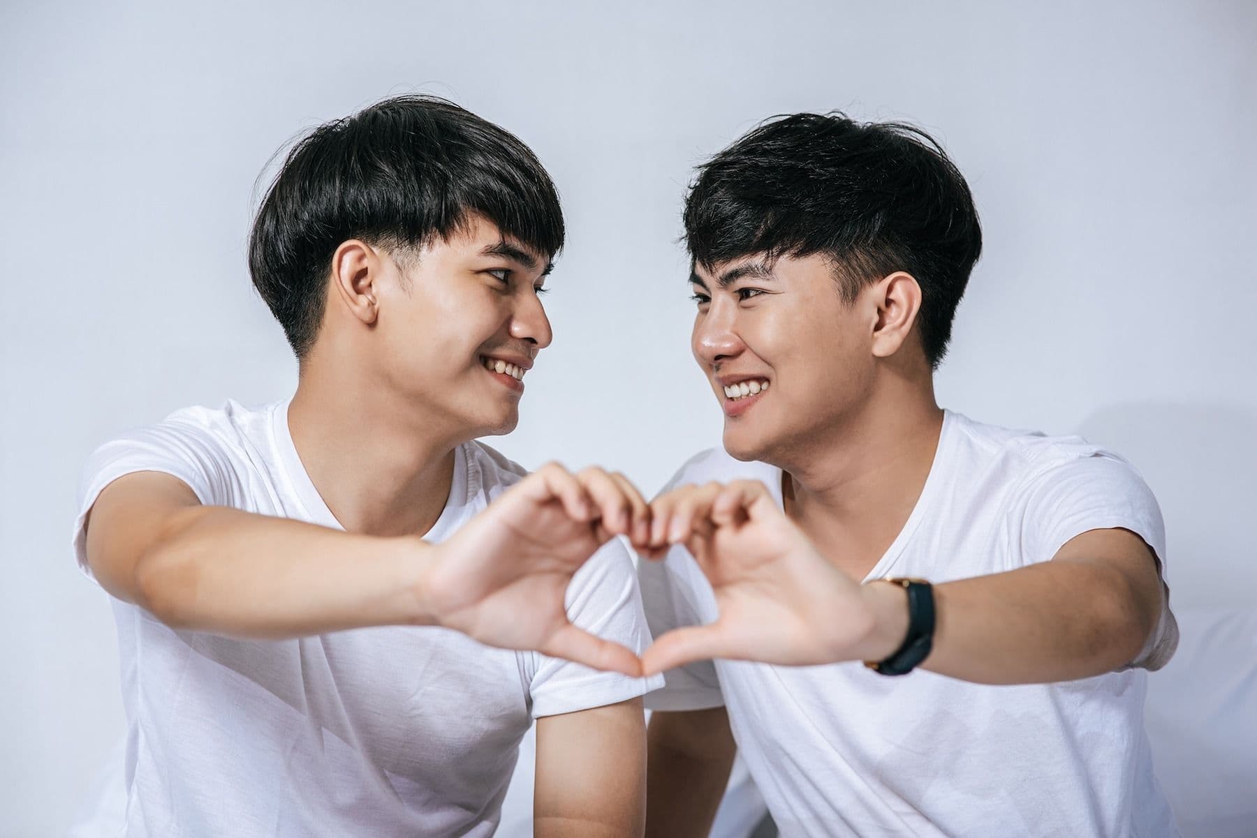 Couple making a heart shape with their hands